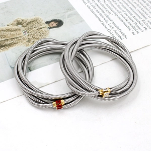 Detail of silver snake chain bracelet with gold-set red and clear cubic zirconia stones