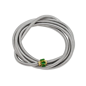 Close-up of silver tubogas wrap bracelet with gold buckle set with green emerald zircons