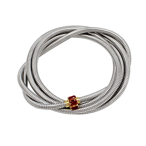 Detail of silver layered bracelet with gold clasp and three inlaid red gemstones