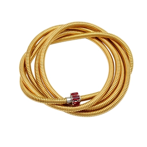 Close-up of gold tubogas coil texture and silver clasp set with red zircons