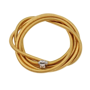 Close-up of golden spiral snake chain bracelet with silver clasp set with clear zircons