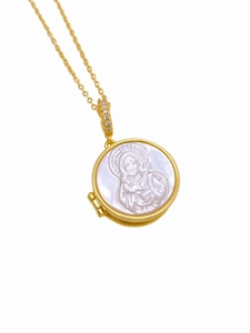 Macro detail of 18K gold necklace with Virgin Mary relief on white shell pendant