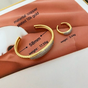 Detail view of 18k gold plated bangle and ring set with sparkling pave-set zirconia stones