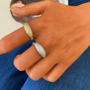 Vintage style gold and silver bands with full diamond pavé inlay worn by a model