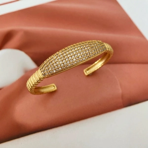 Vintage gold plated C-shaped bangle with full diamond pavé and elegant wavy texture