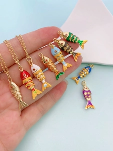 Detail of colorful enamel koi fish pendants with articulated scales and gold plating