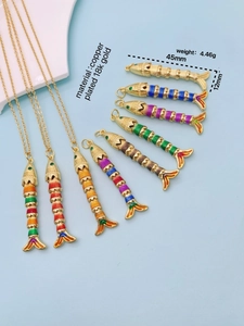 Detail view of 18K gold plated fish pendant featuring colorful enamel and movable joints