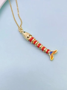 Detail of articulated goldfish pendant with colorful enamel and golden chain
