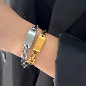 Detail showing brushed finish on silver and gold stainless steel chain bracelets
