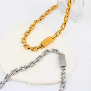 Detail of rectangular chain link necklace set in gold and silver stainless steel