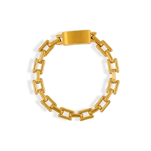 Detail of gold box chain bracelet showing the brushed metal texture and clasp