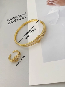 Détail macro de la bague et du bracelet en cœur plaqué or 18K avec zircon incrusté