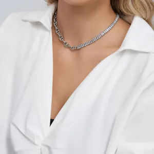 Close-up of horseshoe link chain and rectangular zircon tennis chain necklace detail