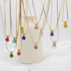 Detailed close-up of colorful round birthstone pendant necklaces on gold-plated chains