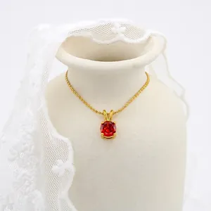 Minimalist gold plated necklace with oval red birthstone pendant on silk twist chain