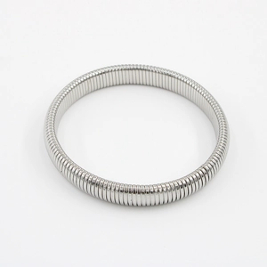 Macro shot of silver stainless steel flexible tubogas bracelet with polished finish