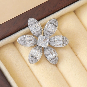 Elegant silver flower brooch with square zircon center and shimmering petals in a gift box