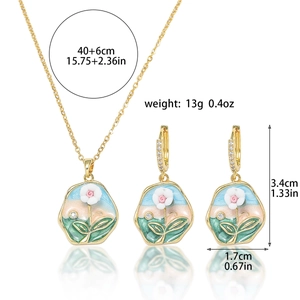 Detailed view of floral enamel necklace and earrings set with crystal accents