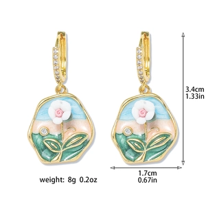 Detail view of enamel flower earrings with dimensions and gold plated rhinestone hoops