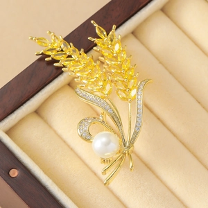 Elegant gold wheat brooch with yellow zircon crystals and a large white pearl in a box