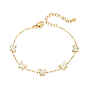 Elegant gold butterfly bracelet with white shell inlays and lobster clasp on white background