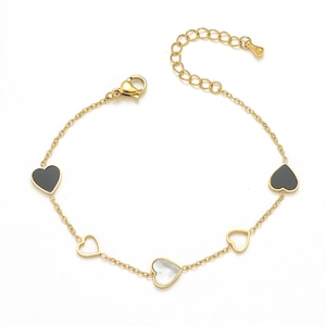 Minimalist gold stainless steel bracelet with black and white heart charms on white background