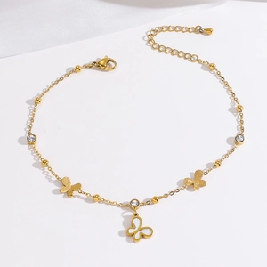 Goldenes Fußkettchen mit Schmetterlingsanhänger und Zirkonia auf Seide