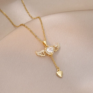 Detail of Cupid angel wing necklace with heart zircon and silk background texture