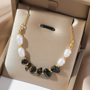 Titanium steel necklace with natural white jade, black onyx beads and gold accents in a box