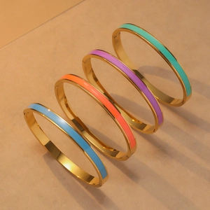Detailed set of four gold enamel bangles in blue, orange, purple and green colors
