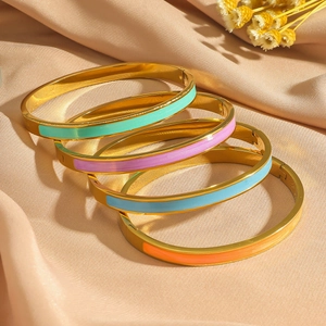 Set of four gold-plated bangles with colorful enamel inlay and hinge closure