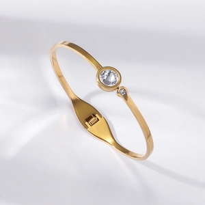 Detailed macro view of gold titanium steel bangle with two sparkling zircon stones