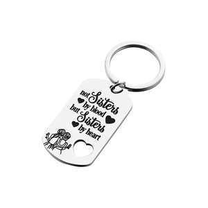 Stainless steel heart keychain engraved with 'Sisters by heart' quote on dog tag
