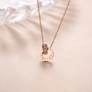 Rose gold titanium steel necklace with Roman numeral rings and crystal pave pendant