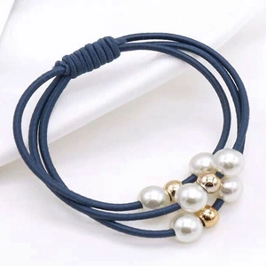 Navy blue triple-strand elastic hair tie decorated with white pearls and gold beads