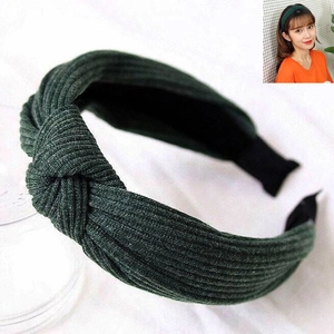 Solid color dark green twisted knot headband for women featuring a ribbed knit fabric texture