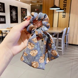 Blue floral scrunchie with orange rose pattern and long bow ribbon streamer for women