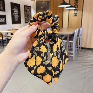 Floral print scrunchie with yellow flower pattern and long ribbon hair tie for women