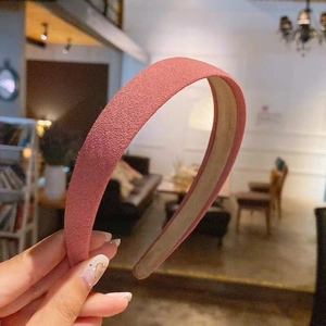 Close-up of pink floral headband with textured velvet matte finish and sturdy inner lining