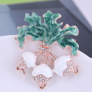 Fashionable radish plant brooch with white bulbs, green enamel leaves, and clear crystals