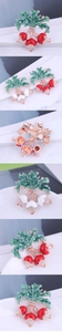 Macro view of radish brooches with green enamel leaves and sparkling crystal rhinestones