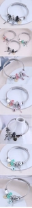 Detail of beaded open bangle featuring bear charms and multi-element crystal pendants