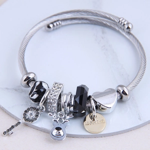 Silver cable cuff bracelet featuring elk charm and crystal beads on marble display