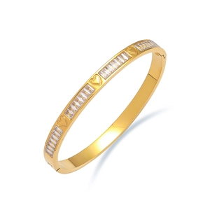Titanium steel bangle with heart relief and rectangular zircon stones in gold finish