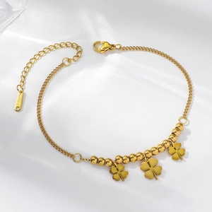 Golden stainless steel chain bracelet featuring clover pendants and delicate bead details