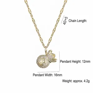 Detailed view of a gold money bag pendant necklace with cubic zirconia and $ symbol