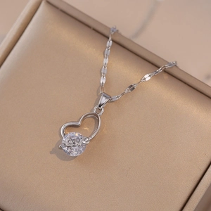 Silver heart necklace with zircon and Love lettering in a golden jewelry box