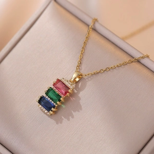 Golden necklace with a pendant of three rectangular red, green, and blue gemstones