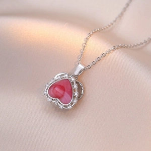 Silver-tone necklace with a pink marble heart pendant surrounded by sparkling zircons