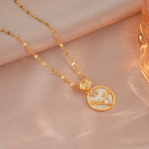 Elegant gold titanium necklace featuring a floral embossed shell pendant and wavy chain